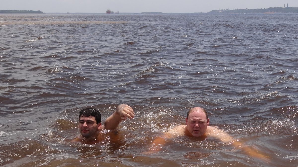 A picture of Graydon and a friend swimming in the confluence of the Rio Negro and Amazon River.